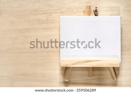 canvas & easel on wood background