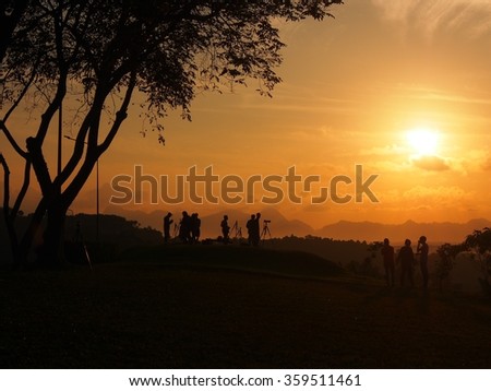 Silhouette of photographer during in sunset.