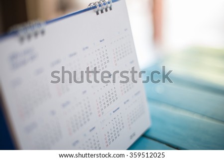 Blurred calendar page blue background.