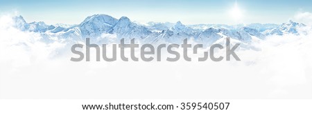 Panorama of winter mountains with clouds, bright sun and copy space Royalty-Free Stock Photo #359540507