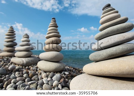 four giant stone stacks against sky on beach