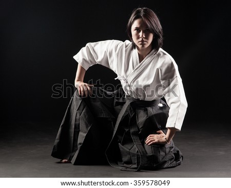  beautiful girl dressed in hakama practicing Aikido 