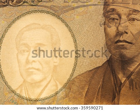 Macro of Ten thousands japanese yen bills on white background, watermark is visible on backlit.