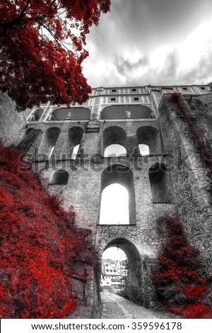 Black and white photo with the color red.  Cesky Krumlov, Czech republic
