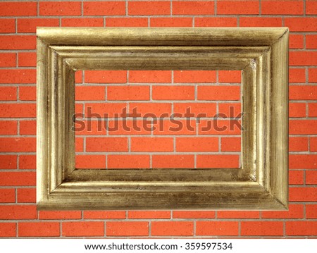 empty golden wooden frame on the red brick wall
