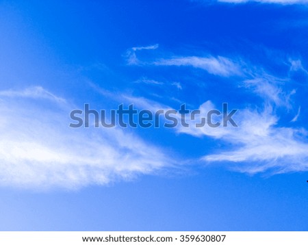 Blue sky background with tiny clouds and space for text.