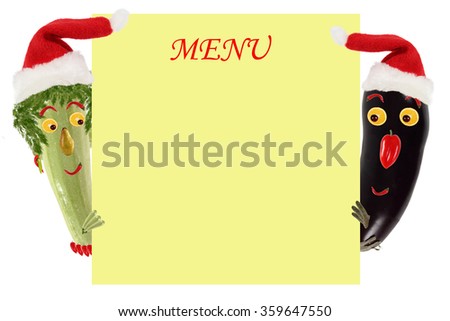 Creative food concept. Funny small zucchini and eggplant in a Santa Claus hat look and smile with sample text.