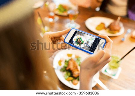 woman photographing food by smartphone 