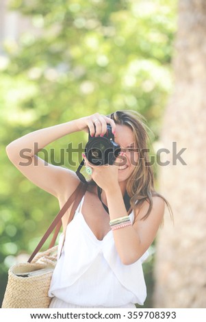 Toned image of Happy woman photographer holding a dslr camera