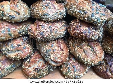 Loaves of brown seeded bread on a market stall