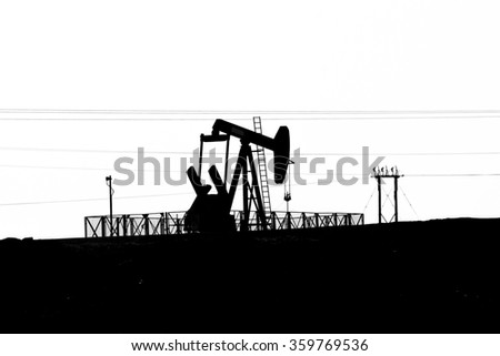  Silhouette of Oil pump in the desert of Bahrain, Middle East. 