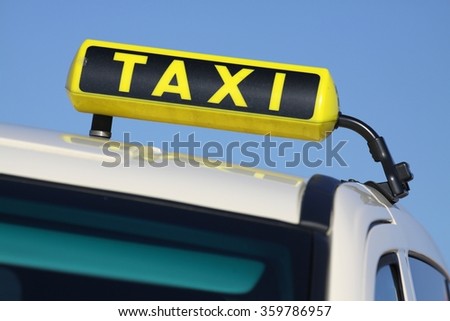 german taxi sign against blue sky
