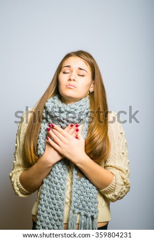 beautiful long-haired blond girl praying religion winter theme concept, photo studio, portrait of a woman isolated on gray background