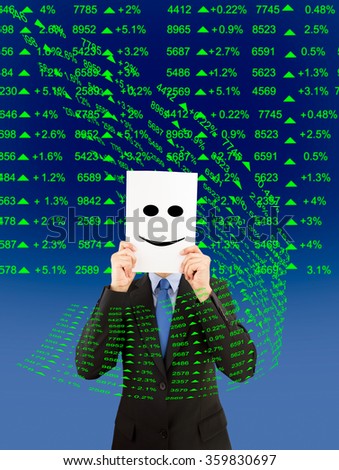 business man hiding his face behind paper with positive market data backgroundstock