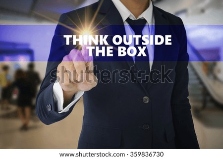 Businessman hand touching THINK OUT SIDE THE BOX tab on virtual screen , business concept , business idea