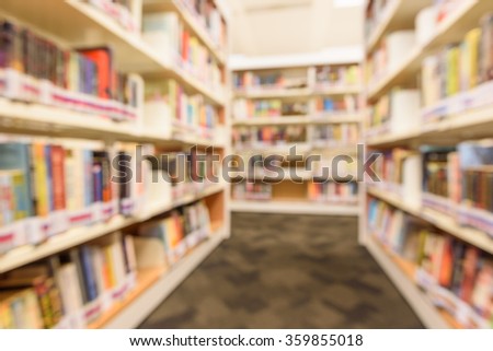 Blurred abstract background of modern public Asian library interior with aisle of bookshelf with textbooks, literature, thesis, magazines. Self-study, educational concept and background