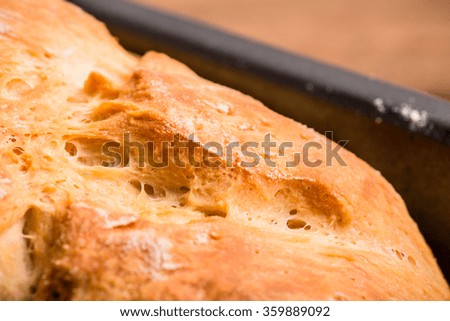 Bread Loaf, on Pan. Homemade Fresh Baked from Oven, Wood Table Background, Vintage Country Rustic Still Life Style. Concept and Idea of Breakfast, Bakery. Selective Focus.