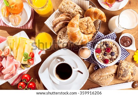 Top view of coffee, juice, fruit, bread and meat on table Royalty-Free Stock Photo #359916206