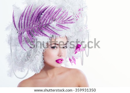 Winter fashion girl portrait, pink lips and flowers on a head