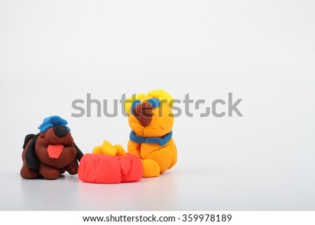 modeling clay dog and cat eating at the same bowl