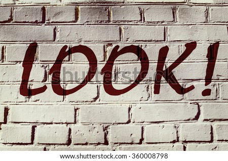 Wall with graffiti that says "Look!" (abstract background, vintage, grunge - concept)