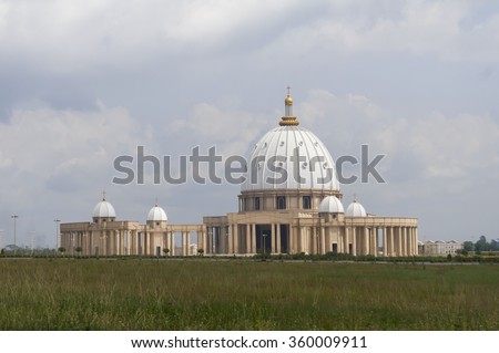Catholic Basilica of Our Lady of Peace (Basilique Notre-Dame de la Paix) in Yamoussoukro, Cote d'Ivoire. Guinness World Records lists it as the largest church in the world. Ivory Coast travel icon. Royalty-Free Stock Photo #360009911