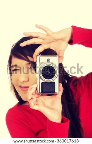 Woman taking a photo with camera.