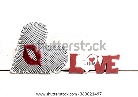 Wooden background with love word and heart as a concept of Valentines day and Love 