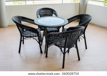 Outdoor rattan furniture set including four chairs and a table