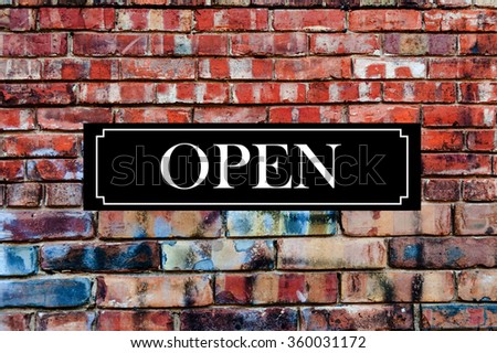 Open Sign on Brick Wall

