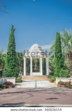 Beautiful white building style in the garden and blue sky background.