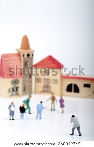 Miniature of a street photographer taking pictures of strangers walking on the streets of a city