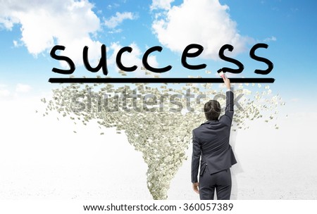 Young businessman painting with a brush the word 'success, dollar tornado under it. Blue sky at the background. Back view. Concept of success.
