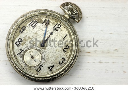 old pocket watch on wooden background