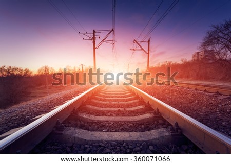 Train platform at sunset. Railroad in Ukraine. Railway landscape.