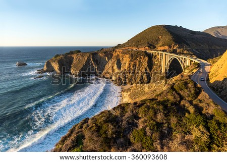 The California coast glows in late afternoon sun in this aerial view of the Pacific Coast Highway. Royalty-Free Stock Photo #360093608