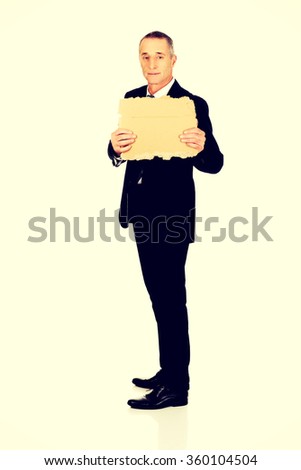 Businessman holding a piece of cardboard