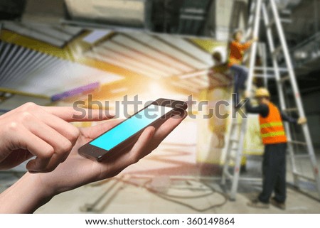 Concept of smart phone in subway site. Double layers view of city scape and indoor hand image.