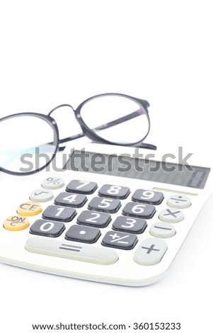 Calculator with eyeglasses isolated on white background, stock photo