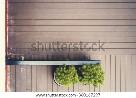Wooden floor with plant and fence background, free space for add text blank natural background