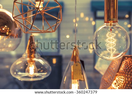 Closeup of several bulbs seeing their tungsten filaments Royalty-Free Stock Photo #360247379