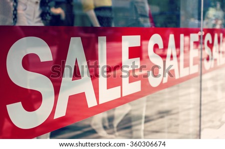 Picture of shop window display with text Sale on red poster