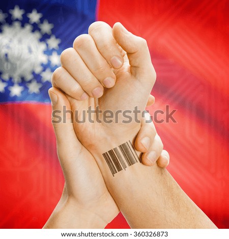Barcode ID number on wrist of a human and national flag on background series - Burma