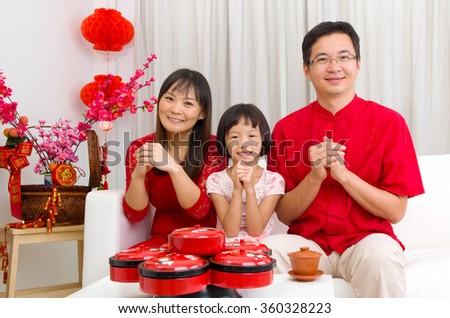 Asian family celebrating chinese new year Royalty-Free Stock Photo #360328223