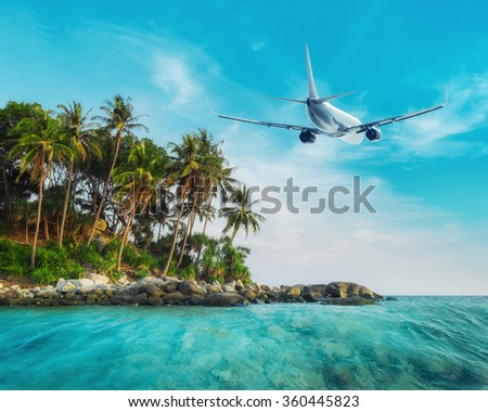 Airplane flying over amazing ocean landscape with tropical island. Thailand travel destinations 
 Royalty-Free Stock Photo #360445823