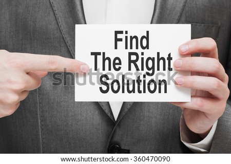 Find The Right Solution. Businessman holding a card with a message text written on it