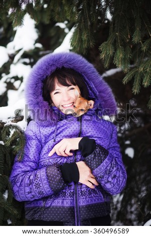 photo of Portrait of smiling  woman with Russian Toy in arms