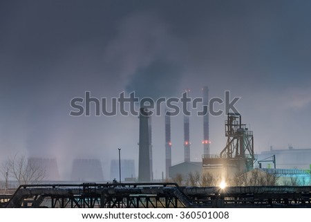 Part of big oil refinery in a foggy full moon night.