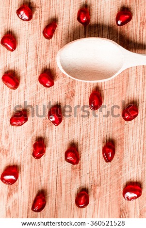 Red pomegranate fruit. Ripe vegetarian food. Sweet juicy fresh organic seed and spoon on wood background. Healthy raw closeup tropical half piece with juice. Tasty dessert. Vintage effect