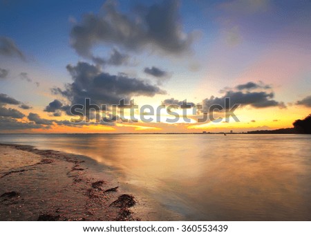 Sunset at Beach. Taken using Slow Shutter Speed. Long Exposure. Motion Blur and Soft Focus due to Long Exposure. Vibrant Colors